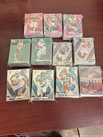 Multiple stacks of sleeved Panini Mosaic football cards on table