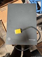 Closed power supply showing Pelco logo and attached power cord