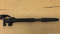 Full view of collapsed Rocketfish monopod showing foam grip, leg sections, and ball head