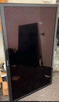 Samsung UN60C6300 TV front view leaning against wall