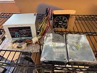Overall lot showing PSU, two sealed Seagate drives, CPU cooler and wiring
