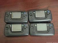 Four Sega Game Gear consoles front view showing screens and controls
