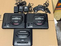 All three Sega Genesis consoles, three power adapters, and controller