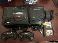 Entire lot: Genesis console, Sega CD, two controllers, AC adapter, two game cartridges