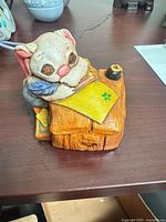 Front view of resin cat figurine on desk