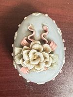 Top view of closed trinket box showing floral decoration