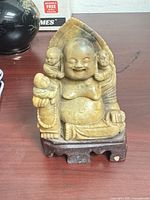 Front view of soapstone Laughing Buddha with children