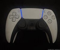 Front view of white and black Sony DualSense PS5 controller powered on
