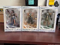 Front view of three sealed Play Arts Kai Final Fantasy XIII figure boxes