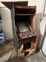 Full front view of arcade cabinet showing CRT, control panel, and missing front panel