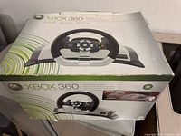 original Xbox 360 Wireless Racing Wheel retail box showing product image and branding