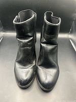Front view of both ankle boots showing toe condition and creasing