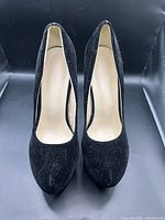 Front view showing both pumps, material texture, wear