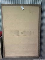 Front view of twin box spring showing beige fabric and staining