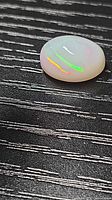 Opal on textured surface showing play-of-colour