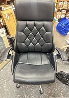 Front view showing full chair, upholstery, stitching pattern, seat and armrests