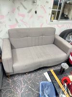 front view of grey futon couch showing overall design