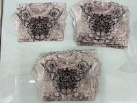 Stacks of folded identical rhinestone graphic tees