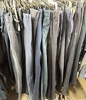 Rack showing multiple pairs of navy pants