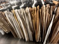 Front view of rack showing multiple khaki pants in varying shades