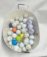 bucket filled with assorted golf balls