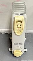Front view of Warm Fusion oil-filled radiator heater showing control panel and caster wheels