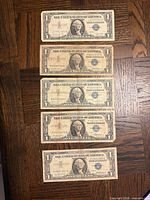 Five 1957 $1 silver certificates laid out