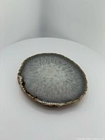 Front view of round agate coaster showing solar eye pattern