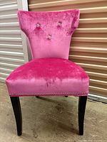 Front view of pink velvet dining chair with rhinestone tufting and nailhead trim
