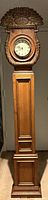 Full front view of carved pine longcase clock with shell crest and round dial