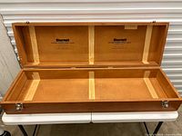 Open case showing interior supports and branding