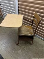 Side view showing chair, desk surface, under-seat shelf