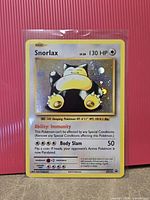 Front of sleeved Snorlax XY179 promo card