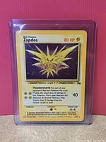 Front of Zapdos Fossil holographic card in sleeve