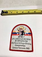Front view of embroidered patch with measuring tape showing size
