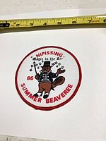 Front view of round embroidered patch showing full design and ruler indicating size