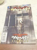 Front cover of Batman #28 comic showing title, issue number, writers, and promotional text