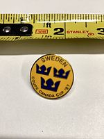 Front of Sweden Canada Cup ’87 enamel lapel pin beside tape for scale