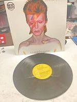 Front cover with Best Buy sticker and vinyl record front side