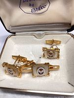 Open case showing cufflinks and studs