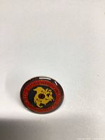 Front of circular enamel union emblem lapel pin