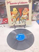 Front sleeve artwork on stand and vinyl record showing blue Sonolux label