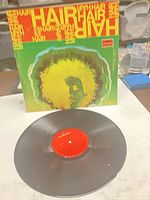 Front cover and vinyl record displayed on table