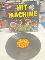 Front cover of Hit Machine LP with vinyl displayed