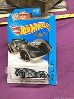 Front of carded Hot Wheels Batman: Arkham Asylum Batmobile showing car and series information