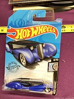 Front of sealed Hot Wheels card showing blue Custom Cadillac Fleetwood
