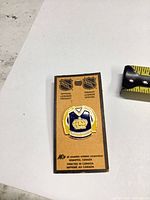 Front view showing pin on NHL licensed card with tape for scale