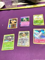 Six Pokémon cards laid out showing fronts and foil effects