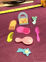 All eight accessories laid out on purple cloth