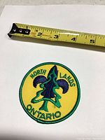 Front view of patch with tape measure showing size